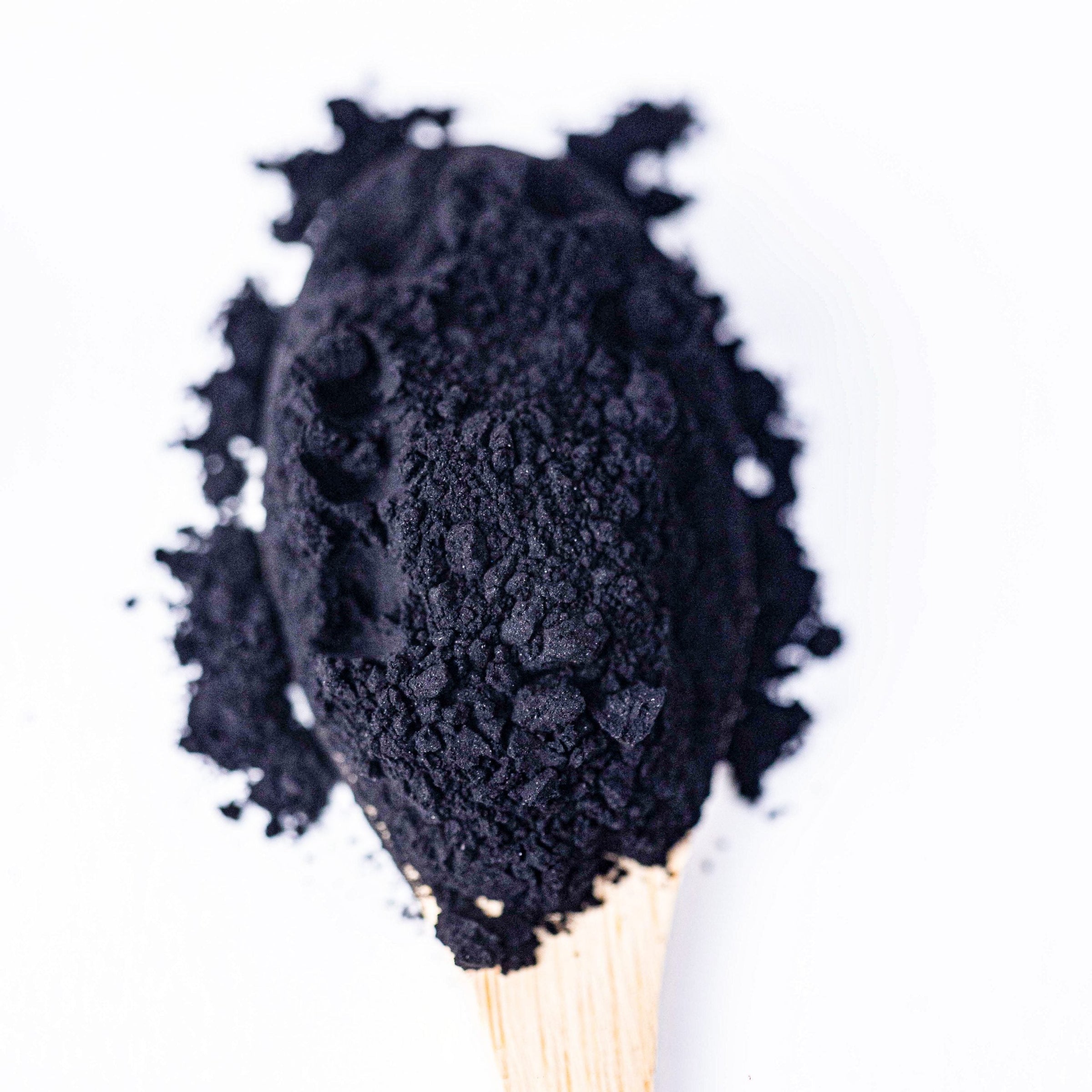 Activated Charcoal powder in a deep black shade, natural food coloring for creative culinary ideas.