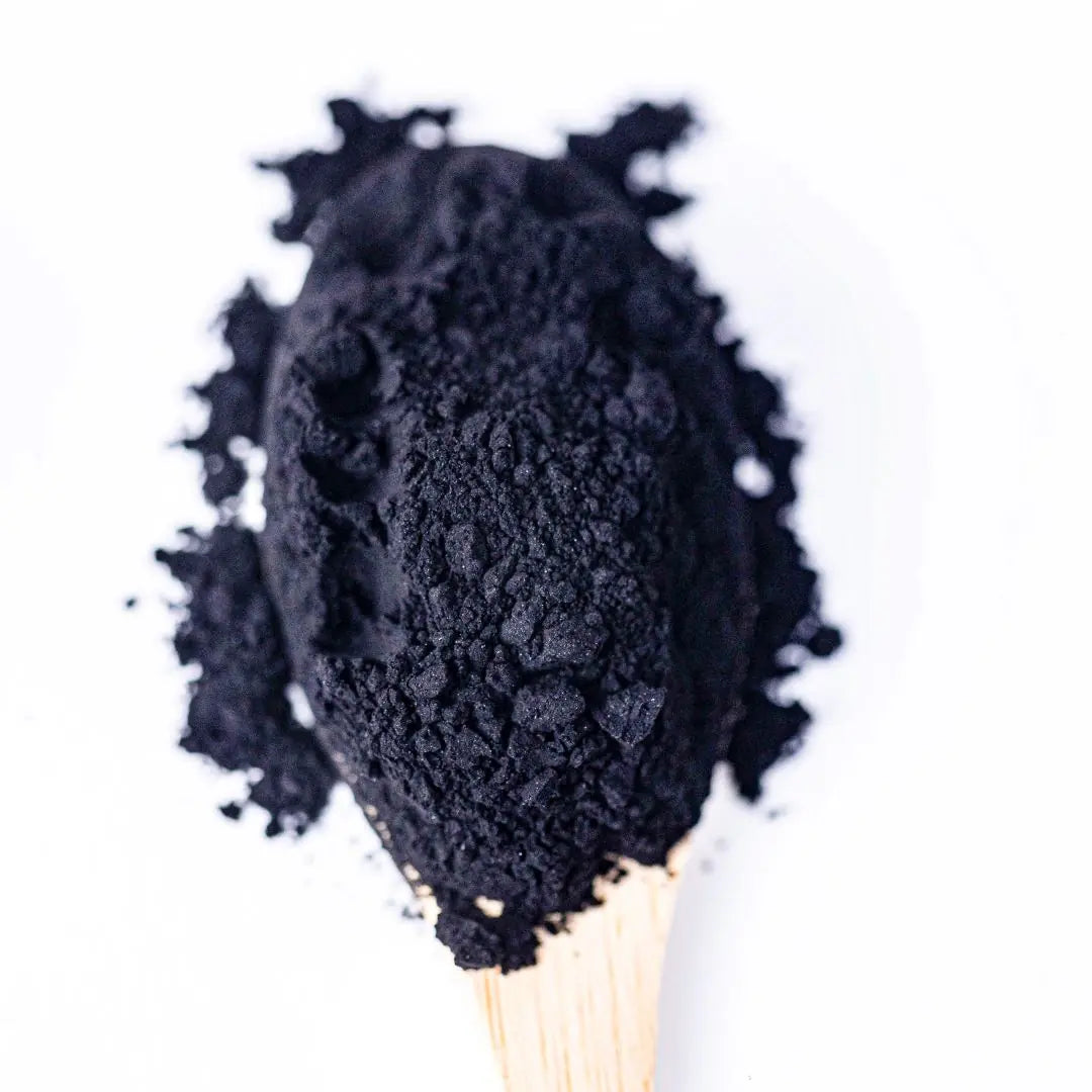 Activated Charcoal powder in a deep black shade, natural food coloring for creative culinary ideas.