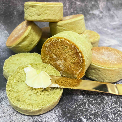 Englis muffins made with matcha powder, butter and knife