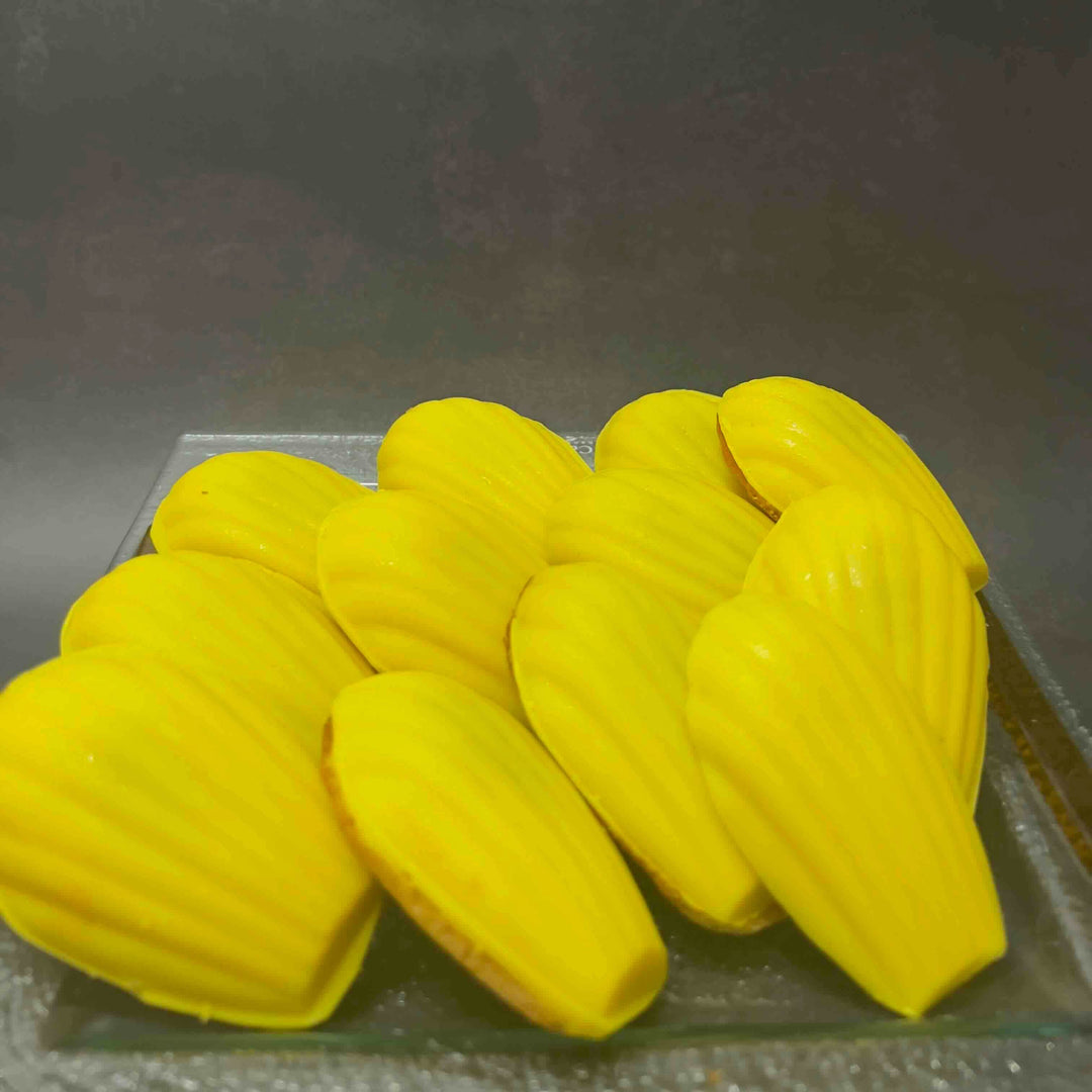 Yellow madeleine on a dark surface